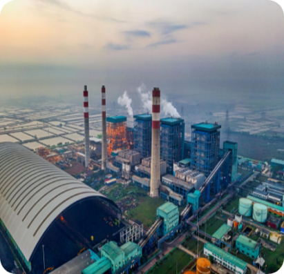 A power plant situated in the center of an urban area, surrounded by buildings and infrastructure.
