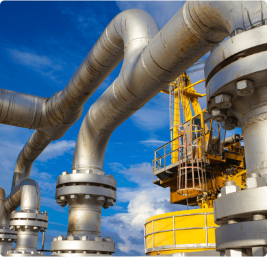 Metal pipes and yellow structure against blue sky.
